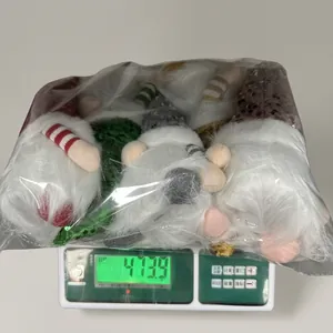 Detail showing the total weight of 473.9g for a stack of plush Christmas gnome figurines