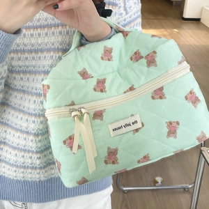 Quilted light green wash bag with teddy bear pattern and elegant zipper ribbon tie