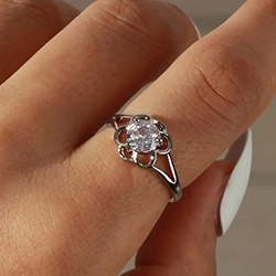 Detailed macro view of an open silver floral ring featuring a large sparkling zircon stone