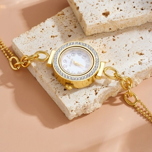 Elegant gold titanium steel watch with diamond-set dial on textured stone
