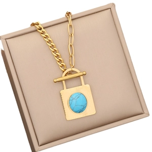 Gold stainless steel necklace set with turquoise pendant in a beige jewelry box