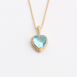 Elegant gold heart pendant necklace with blue gemstone and clear crystals for women