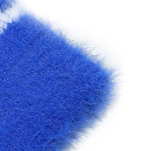 Macro shot of plush bright blue faux fur fibers on a winter warm beanie hat detail