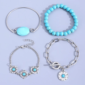Bohemian turquoise bracelet set with four silver bangles on a lavender background