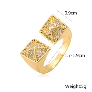 Detail view of gold-plated geometric ring with pyramid zircons and size measurements