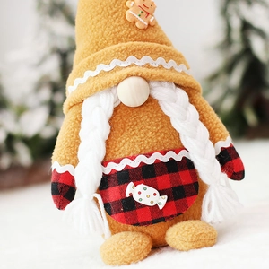 Gingerbread Christmas gnome with blonde braids and plaid apron in festive winter setting