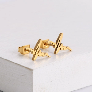 Minimalist gold heartbeat stud earrings made of 304 stainless steel on a white stone base