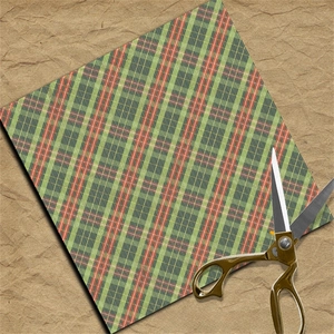 Classic red and green plaid scrapbooking paper on brown kraft background for DIY crafts