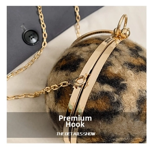 Detailed macro view of the leopard print faux fur round bag with gold chain and metal hook
