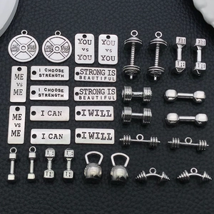 Detailed collection of antique silver fitness charms including dumbbells and weight plates
