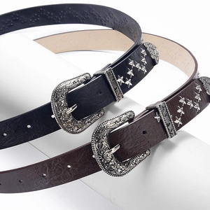 Retro PU leather belts with metal star studs and western buckle on white pedestal