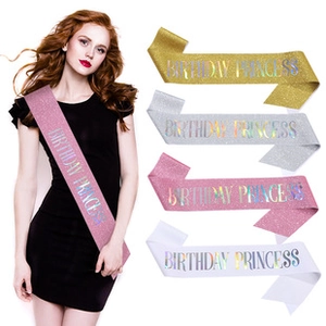 Close-up of BIRTHDAY PRINCESS glitter sashes in gold, silver, pink, and white colors
