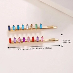 Set of two gold hair clips with colorful rectangular crystal rhinestones on white base