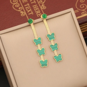 Golden double-layer butterfly drop earrings with green enamel in a velvet jewelry box