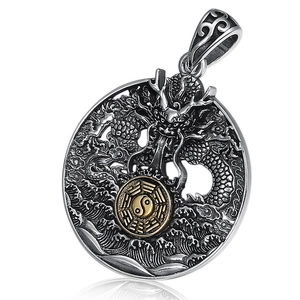 Vintage sterling silver dragon pendant with golden Tai Chi Ba Gua emblem and intricate carvings