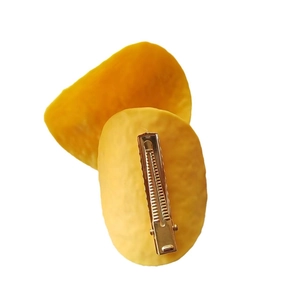 Front and back view of creative mango slice hair clips with realistic fruit texture