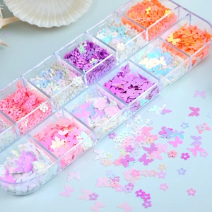 Close-up of 12-grid storage box with colorful butterfly and flower nail art glitter sequins