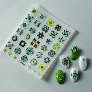 Detail of 5D embossed nail stickers featuring vintage green bohemian patterns and textures