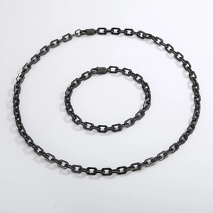 Detail view of black stainless steel rectangle link chain necklace and bracelet set