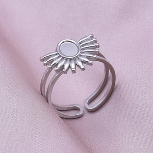 Close-up of adjustable stainless steel oval sunburst ring on elegant pink silk