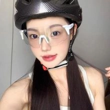 Close-up of white cycling goggles and carbon fiber texture helmet worn by a model outdoors