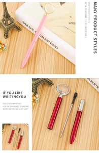 Detailed view of pink heart diamond pen and disassembled red metal pen with refill