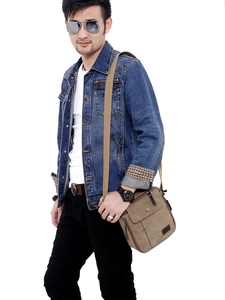Brown canvas messenger bag for men with multiple pockets shown on model with white background