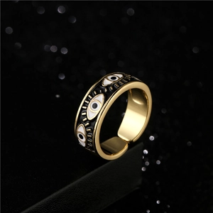 Golden Evil Eye adjustable open ring with colorful enamel inlay on black pedestal
