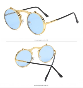 Detail of steampunk flip-up sunglasses with gold metal frame and sky blue round lenses