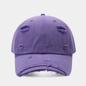Detailed close-up of distressed ripped details on purple vintage cotton baseball cap