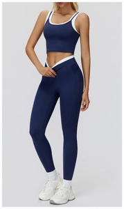 Detail of high-waist yoga leggings with V-shaped waistband and navy crop top sports set