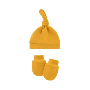 Detailed view of soft yellow knitted newborn knotted hat and scratch-free mittens set