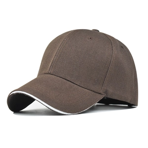 Detailed close-up of dark brown baseball cap featuring a white sandwich brim design