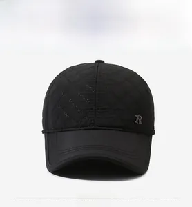 Detail of winter baseball cap with quilted diamond pattern and metallic R logo accent