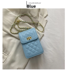 Detail of light blue quilted phone bag featuring a gold chain strap and metal ball adjuster