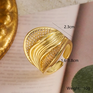 Macro shot of 18k gold plated wave ring with pave zirconia and 2.3cm width detail