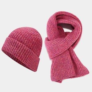 Detailed texture of thick rose red knit hat and scarf set for winter outdoor warmth