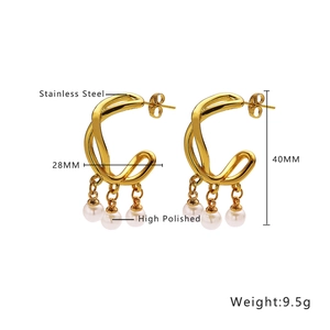 Detailed shot of gold twisted hoop earrings with triple pearl drops in stainless steel