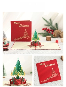 Macro detail of 3D pop-up Christmas tree card with red laser-cut gift box decorations