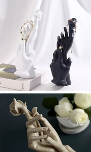 Detail of hand-shaped resin jewelry holder with rose design for rings and bracelets