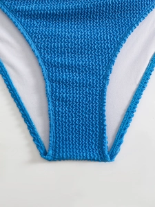 Detail view of blue seersucker bikini bottom with crinkle texture and white mesh lining