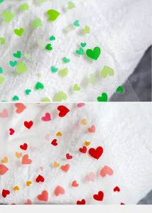 Macro detail of 3D translucent heart nail art stickers in vibrant green and red shades