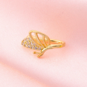 Macro shot of a golden butterfly nose ring featuring intricate white zircon wing detailing