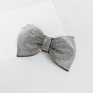 Detailed macro view of the sparkling rhinestone bow hair clip with layered 3D design