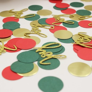 Macro shot of Joy letters and red, green, gold glitter confetti for Christmas decor