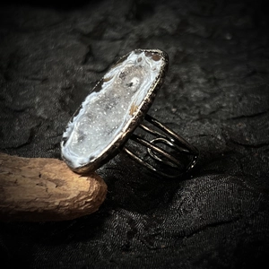 Detailed view of large natural geode stone set in vintage silver-plated handmade ring