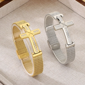 Detail view of gold and silver cross bracelets with metal mesh bands and inlaid zircons