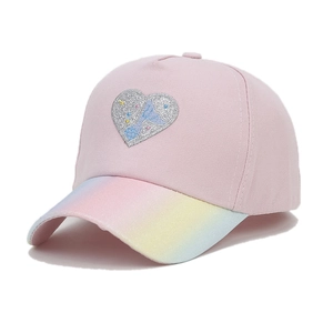 Detail of pink toddler baseball cap with glitter heart patch and rainbow gradient brim