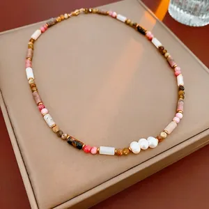 Handmade bamboo style pearl necklace with pink quartz beads on velvet jewelry display