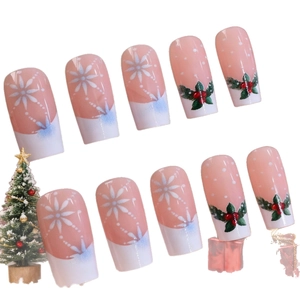 French Christmas press-on nails with snowflake and holly leaf designs in coffin shape